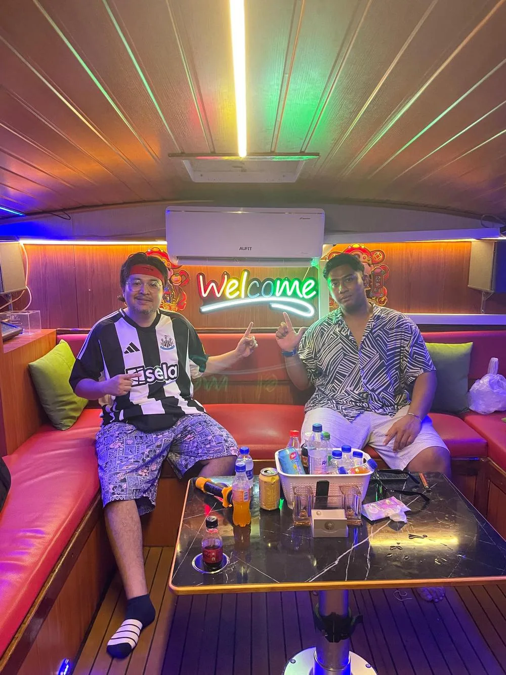 popular Facebook Live host, Mr Nizril (L), and his camera assistant, Aliff, onboard the Penang sunset cruise