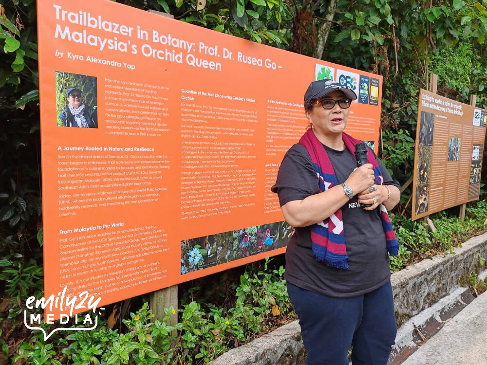 Prof. Dr. Rusea Go poses with her info board